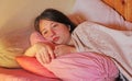 A sick teenage girl lies in bed