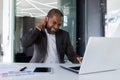 Sick tired man at workplace, businessman has severe neck pain, long sitting work, overworked african american man Royalty Free Stock Photo