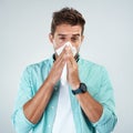 Sick, tissue and portrait of man blowing nose in studio with flu, illness and virus on white background. Health Royalty Free Stock Photo