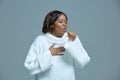 Sick unhealthy african american young woman coughing suffering from flu or bronchitis. Advertising of cough syrup Royalty Free Stock Photo