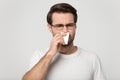 Sick guy sneezing wiping nose or suffers from unpleasant smell