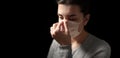 Sick woman adjusting protective medical face mask