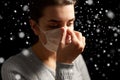 Sick woman adjusting protective medical face mask