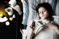 Sick woman in bed,calling in sick,day off from work.Thermometer to check temperature for fever Royalty Free Stock Photo