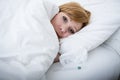 sick woman in bed with thermometer feverish weak suffering cold winter flu virus