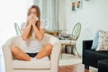 Sick woman blowing her nose at home in the living room Royalty Free Stock Photo