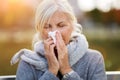 Senior woman blowing her nose Royalty Free Stock Photo