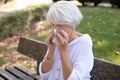sick woman blows nose in handkerchief Royalty Free Stock Photo