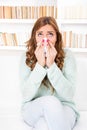 Sick woman caught cold blowing her nose into handkerchief Royalty Free Stock Photo