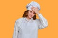 Sick woman chef is sad with her hands to her sore head on studio background, mockup copy space Royalty Free Stock Photo