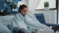 Sick woman with cold using blanket for wamth at home. Royalty Free Stock Photo
