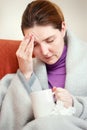 Sick woman covered with blanket at home Royalty Free Stock Photo