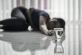 Sick woman crawling toward a glass of water