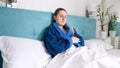 Portrait of sick woman feeling unwell lying in bed at bedroom Royalty Free Stock Photo