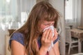 Sick woman with flu or cold sneezing into handkerchief Royalty Free Stock Photo