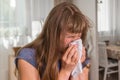 Sick woman with flu or cold sneezing into handkerchief Royalty Free Stock Photo