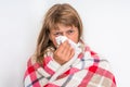 Sick woman with flu or cold sneezing into handkerchief Royalty Free Stock Photo