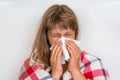 Sick woman with flu or cold sneezing into handkerchief Royalty Free Stock Photo