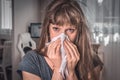 Sick woman with flu or cold sneezing into handkerchief Royalty Free Stock Photo