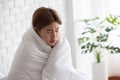 Sick woman has fever cold at home with blanket cover on body virus infection,corona virus 2019 or COVID-19