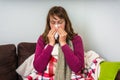 Sick woman having flu and blowing her runny nose Royalty Free Stock Photo