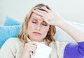 Sick woman with headache lying on the sofa at home Royalty Free Stock Photo