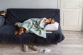 Sick woman at home lying in bed with her Vizsla dog, suffering from allergy, flu symptom, fever Royalty Free Stock Photo