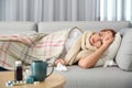 Sick woman lying on sofa. Influenza virus Royalty Free Stock Photo