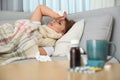 Sick woman lying on sofa. Influenza virus Royalty Free Stock Photo