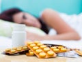 Sick woman and pills from her medical treatment