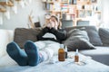 Sick woman with flu, cold, fever or virus sitting on sofa at home Royalty Free Stock Photo