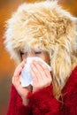 Sick woman sneezing in tissue outdoor Royalty Free Stock Photo