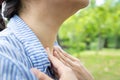 Sick woman suffering from sore throat,painful swallowing,tonsillitis,irritation,asian female patient checking thyroid gland by Royalty Free Stock Photo