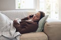 Sick woman, tissue and phone call with flu for help, advice or recovery on living room sofa at home. Tired female person