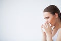 Sick woman using paper tissue, headcold problem