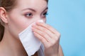 Sick woman using paper tissue, headcold problem