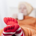 Sick women in funny toesocks on couch