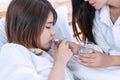 Woman have good friend to take care of her, giving and entering medicine or pill. Young girl lying on the bed with cold and