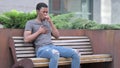 Sick Young Young African Man Coughing on Bench Outdoor Royalty Free Stock Photo