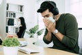 Sick young caucasian business man wearing protective face mask having cold fever Royalty Free Stock Photo