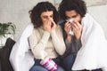 sick young couple blowing noses into napkins Royalty Free Stock Photo