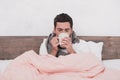 Sick young man drinking hot beverage concept Royalty Free Stock Photo