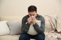 Sick man sneezing at home. Influenza virus Royalty Free Stock Photo