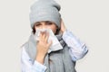 Sick young woman blow nose suffering from flu Royalty Free Stock Photo