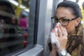 Sick young woman blowing her nose Royalty Free Stock Photo