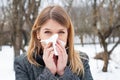 Sick young woman blowing her nose Royalty Free Stock Photo