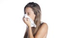 Sick young woman blowing her nose Royalty Free Stock Photo