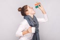 Sick young woman holding cup with tea, many pills, antibiotics.