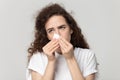 Sick young woman use tissue blowing runny nose Royalty Free Stock Photo
