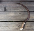 Sickle on wooden background, close-up, reaping hook, wooden Royalty Free Stock Photo